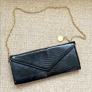 Black clutch bag with gold chain